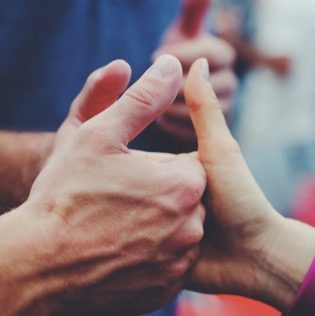 An image of people showing a thumbs up